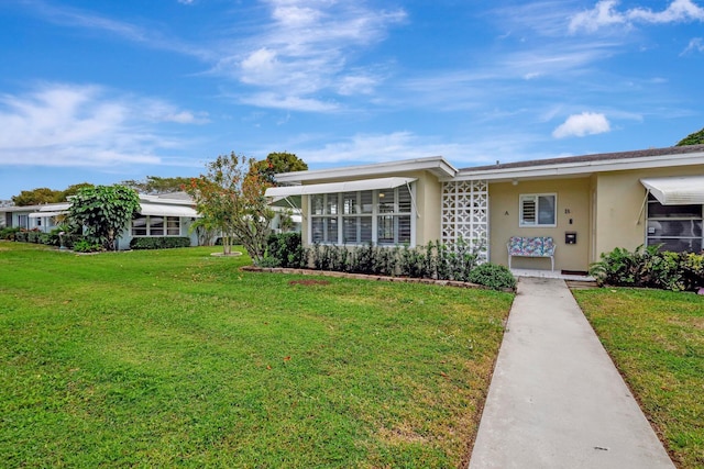 ranch-style home featuring a front yard