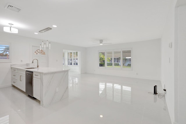 kitchen featuring sink, white cabinets, hanging light fixtures, stainless steel dishwasher, and ceiling fan