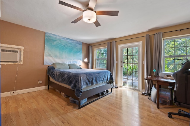 bedroom featuring light wood-style floors, access to outside, baseboards, and a ceiling fan