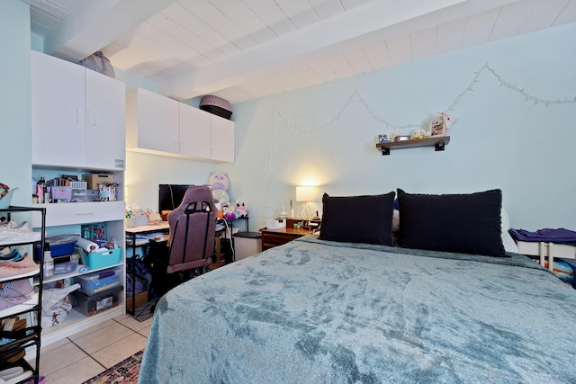 bedroom featuring beamed ceiling and light tile patterned flooring