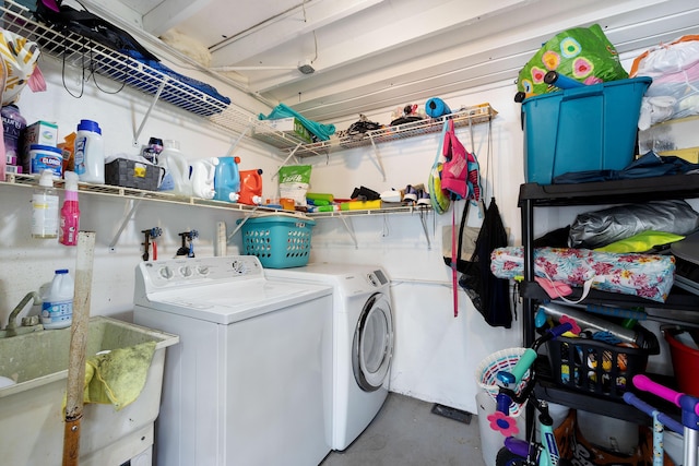 laundry area featuring laundry area, independent washer and dryer, and a sink