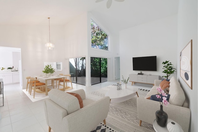 living area with a chandelier, a high ceiling, and light tile patterned floors