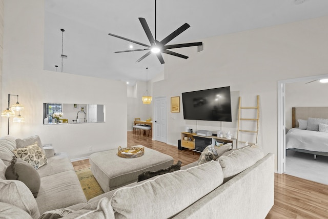 living room with ceiling fan, high vaulted ceiling, and hardwood / wood-style floors