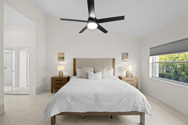 bedroom featuring lofted ceiling, light tile patterned floors, and ceiling fan