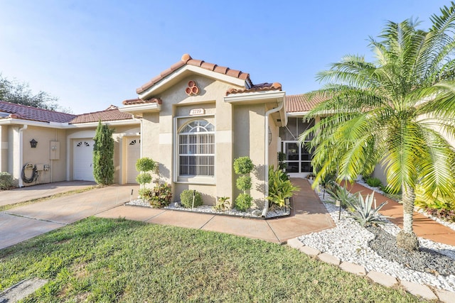 mediterranean / spanish-style home with a garage and a front yard