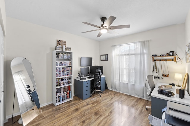 home office featuring hardwood / wood-style flooring and ceiling fan