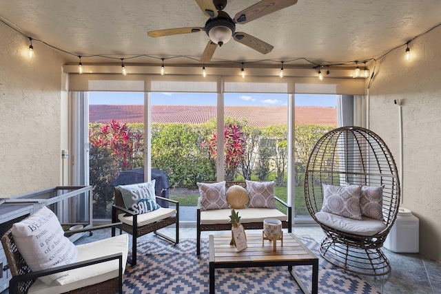 sunroom / solarium featuring ceiling fan