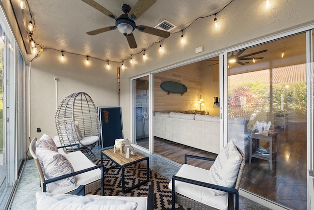 sunroom with track lighting and ceiling fan