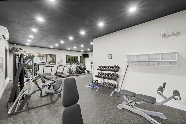 gym featuring a wall unit AC