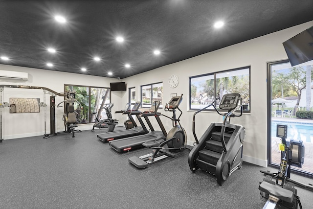 workout area featuring an AC wall unit