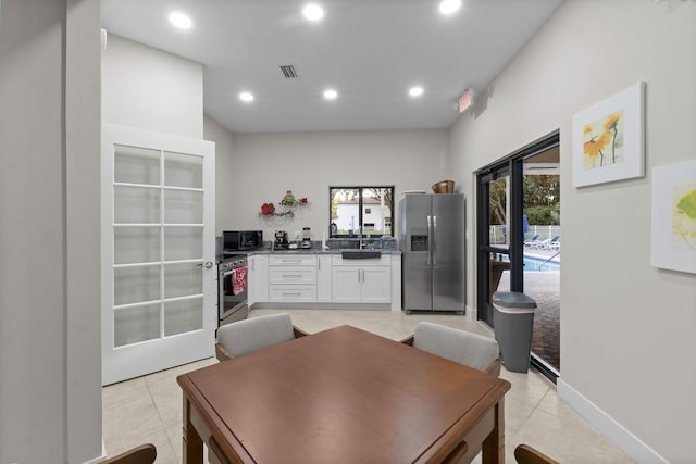 tiled dining space featuring sink