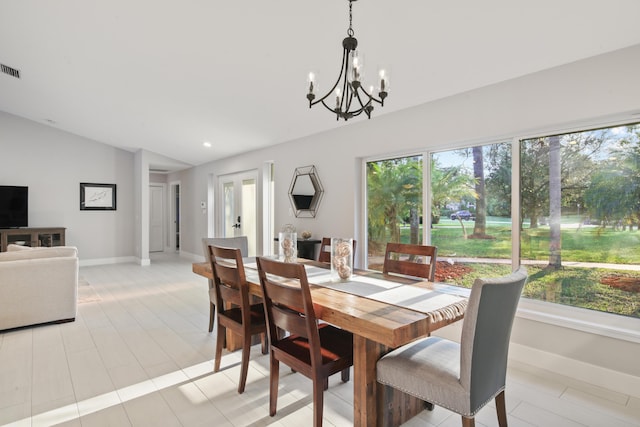 dining space with vaulted ceiling, a chandelier, visible vents, and baseboards