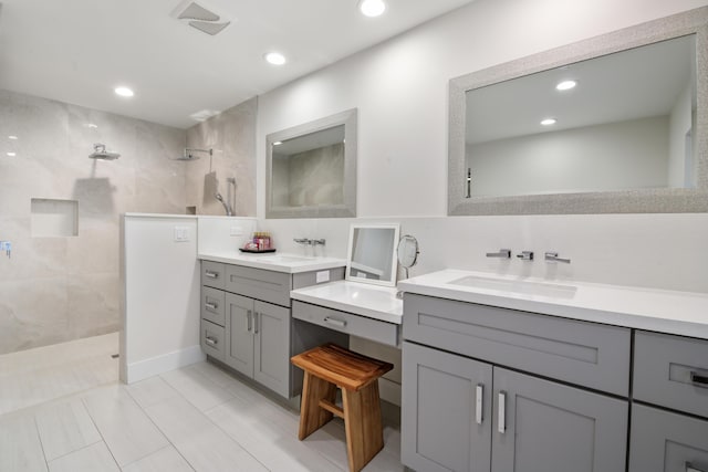 bathroom featuring two vanities, a sink, visible vents, and walk in shower