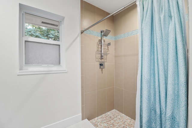 bathroom featuring a shower stall