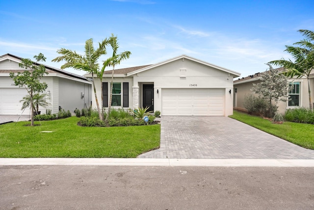 single story home featuring a garage and a front yard