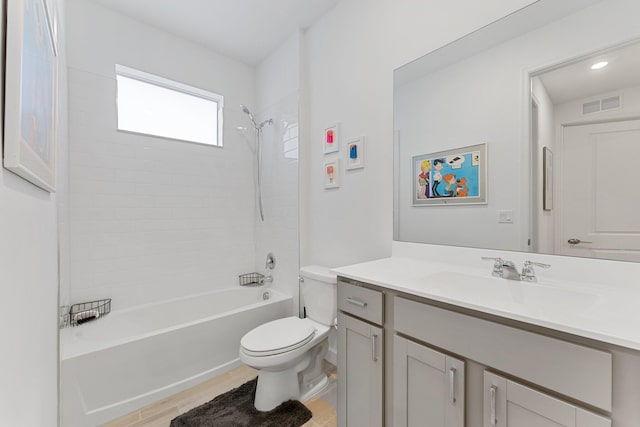 full bathroom featuring vanity, toilet, and tiled shower / bath