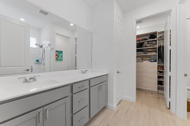 bathroom with vanity, hardwood / wood-style floors, and a shower with shower door