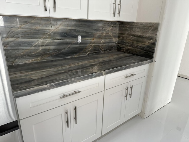 kitchen featuring backsplash and white cabinets