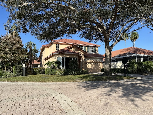 mediterranean / spanish home featuring a garage