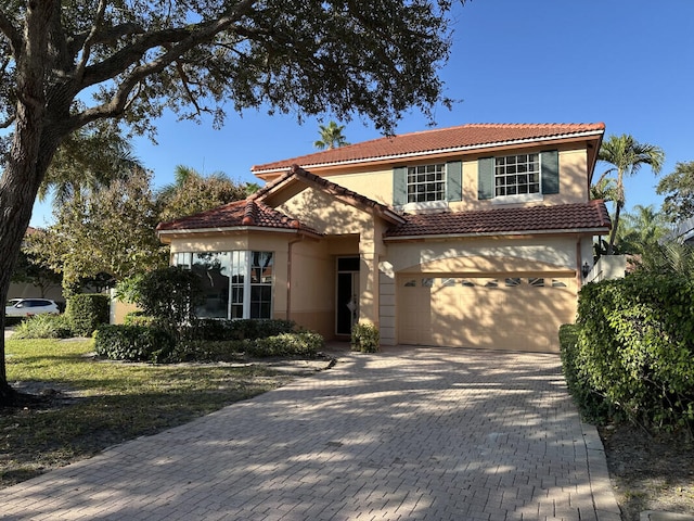 mediterranean / spanish-style house with a garage