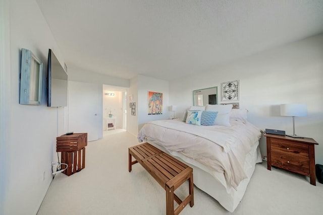 carpeted bedroom featuring ensuite bathroom