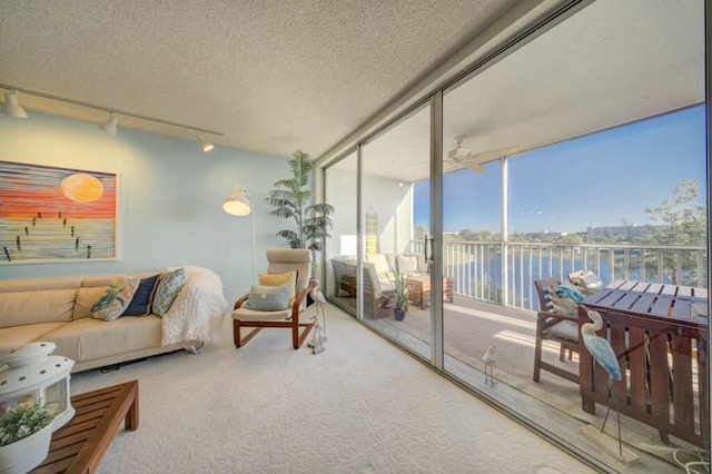 sunroom / solarium featuring a water view