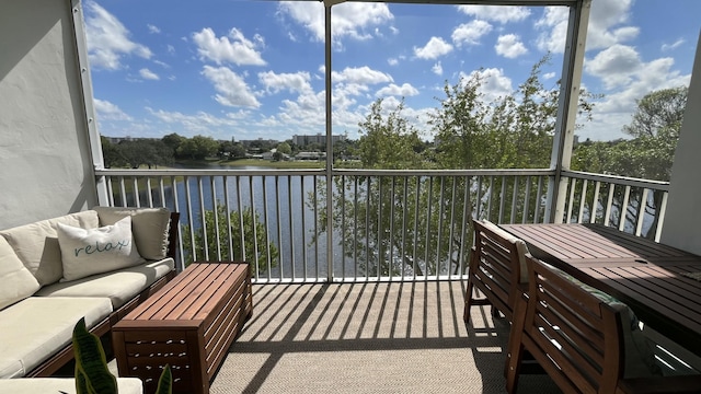 balcony featuring a water view and an outdoor hangout area