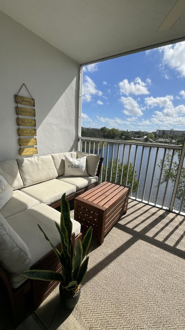 balcony with a water view and outdoor lounge area