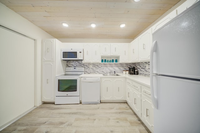 kitchen with white cabinetry, white appliances, sink, and decorative backsplash