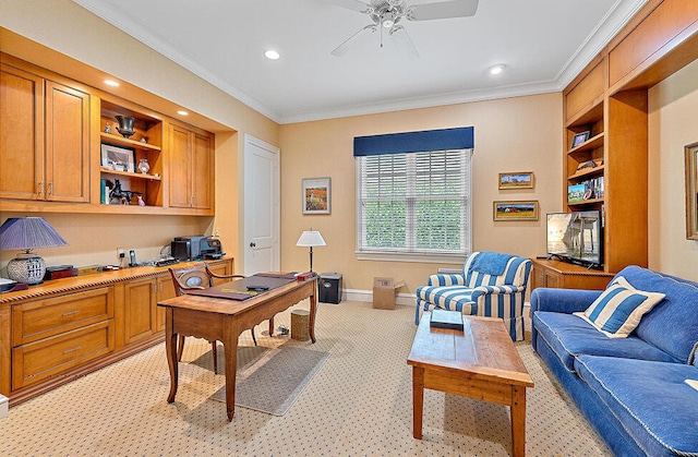 office space featuring ornamental molding, built in desk, ceiling fan, and built in shelves