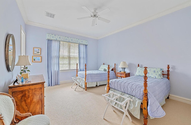 bedroom with ornamental molding, light colored carpet, and ceiling fan