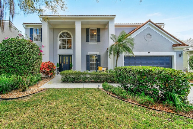 view of front of home featuring a front lawn and a garage