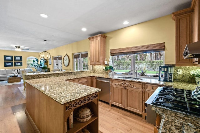 kitchen with light hardwood / wood-style flooring, sink, backsplash, dishwasher, and light stone countertops