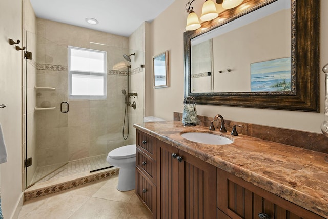 bathroom featuring an enclosed shower, vanity, toilet, and tile patterned floors