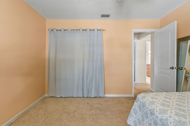 carpeted bedroom with a textured ceiling