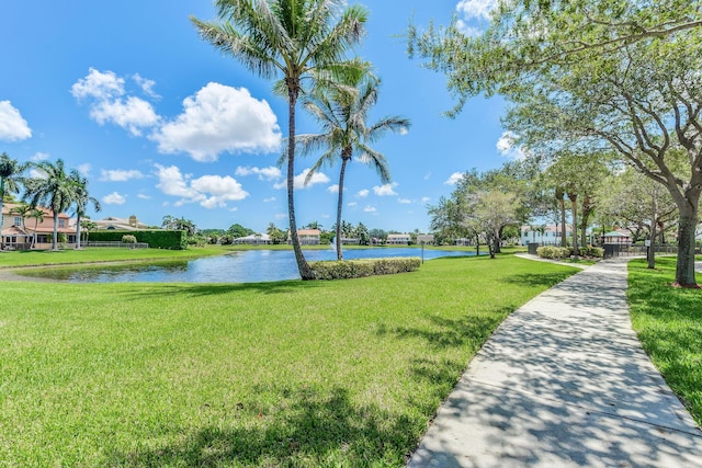 view of home's community featuring a water view and a lawn