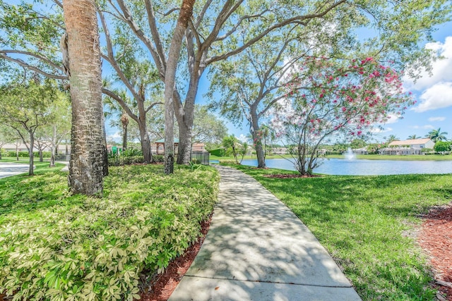 view of home's community featuring a yard and a water view