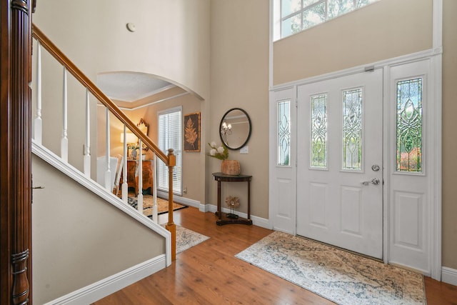 foyer entrance featuring a high ceiling and hardwood / wood-style flooring