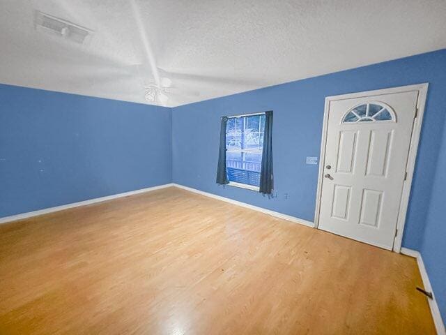 entrance foyer with ceiling fan, hardwood / wood-style floors, and a textured ceiling