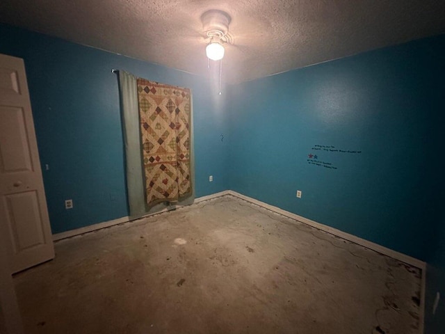 unfurnished bedroom featuring concrete floors and a textured ceiling