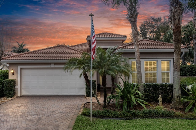 mediterranean / spanish-style house featuring a garage