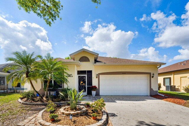 8233 Maidencane Pl, Port Saint Lucie, FL 34952 - ranch-style home with an attached garage, stucco siding, central AC, and driveway