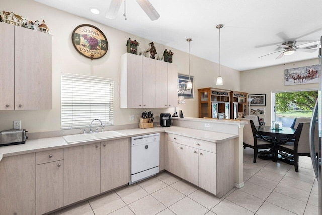 kitchen featuring a peninsula, ceiling fan, a sink, and dishwasher