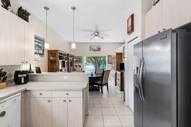 kitchen with a ceiling fan, dishwasher, a peninsula, stainless steel fridge, and light countertops