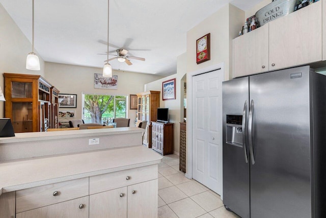 kitchen with pendant lighting, ceiling fan, light tile patterned flooring, stainless steel fridge with ice dispenser, and light countertops