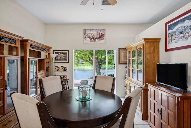 dining area featuring light tile patterned floors, visible vents, and a ceiling fan
