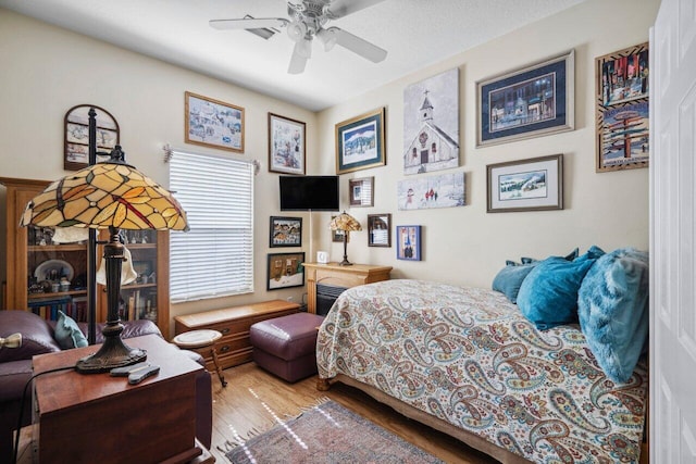 bedroom featuring a ceiling fan and wood finished floors