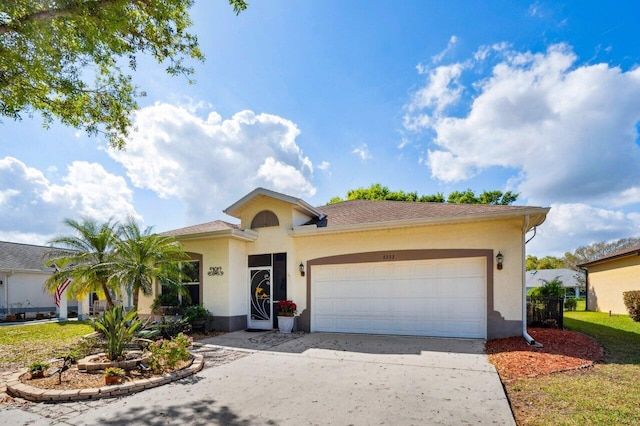 ranch-style house featuring driveway, stucco siding, and an attached garage