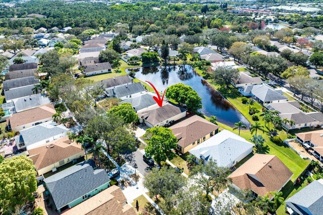 drone / aerial view featuring a water view and a residential view