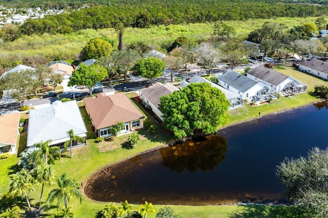 aerial view featuring a water view, a residential view, and a view of trees